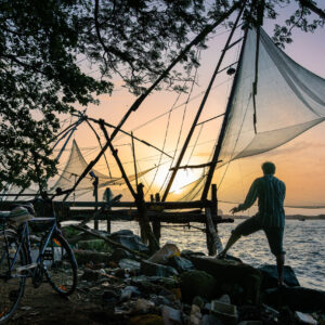fort kochi fishing nets by sunset with fisherman